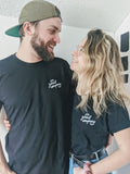 a guy and a girl wearing a Vic Vandenberg x Good Co. | Limited Run T-Shirt