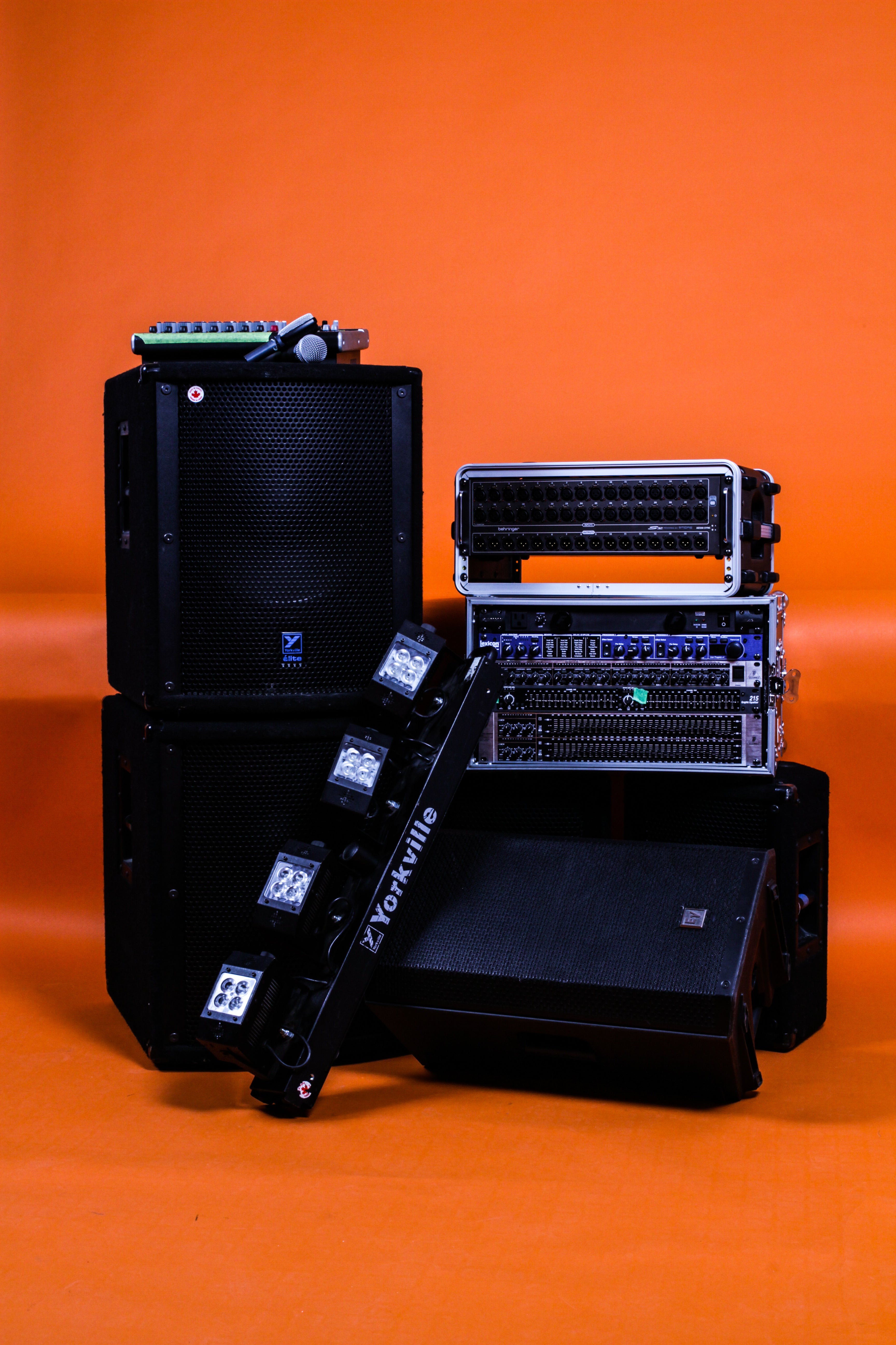 event and sound production equipment displayed in front of orange background